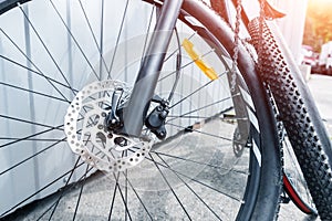 Close-up detail disassembled black carbon fiber bicycle with removed wheel and tyre after puncture or accident at repair