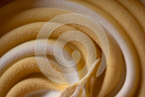Close up detail of frozen spial lines of a white - brown colored ice cream.