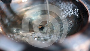 Close up detail of a garden water feature with running water