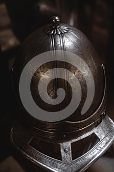 Close up detail of helmet, armour of the medieval knight. Metal protection of the soldier. Steel Plate. Rivets and engraving, dark