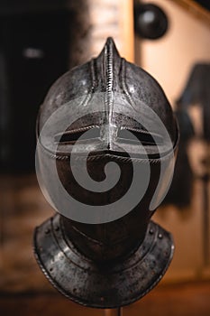Close up detail of helmet, armour of the medieval knight. Metal protection of the soldier. Steel Plate. Rivets and engraving, dark