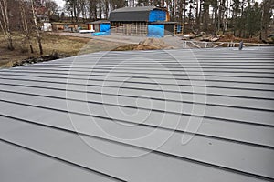 Close-up detail of house roof made from gray metal sheets