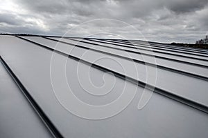 Close-up detail of house roof made from gray metal sheets