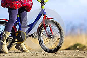 Close-up detail of little girl child feet on a child bicycle