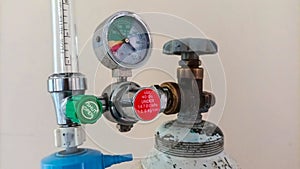 Close-up detail of medical oxygen tank with regulating valve