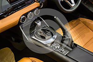 Close up of detail modern luxury car Interior - steering wheel, shift lever and dashboard