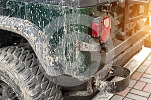 Close-up detail mud dirty wheel of off-road lifted awd ATV SUV car after extreme rally cross competition. Tuned all-terreain-