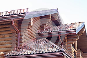 Close-up detail of new modern wooden warm ecological cottage house top with shingled brown roof
