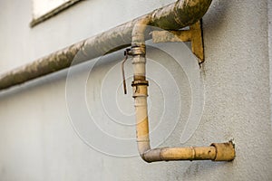 Close-up detail of old dirty painted yellow natural gas pipes wi