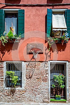 Close up detail with old medieval architecture venetian window. Open wooden shutters