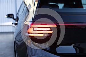 Close up detail on one of the LED red taillight modern luxury car. Exterior detail automobile. Car back lights shining
