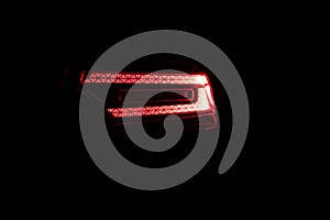 Close up detail on one of the LED red taillight modern luxury car. Exterior detail automobile. Tail light car. Detail on