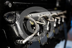 Close-up of a detail of a rare car engine. Metal mechanisms. Automotive industry