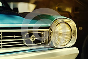 Close-up detail of retro car. Selective focus on the car`s headlight