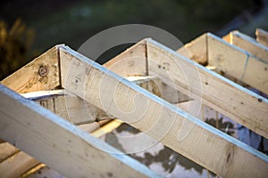 Close-up detail of roof frame of rough wooden lumber beams on background of misty mountain landscape in ecological area. Building