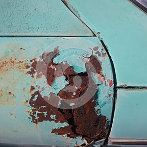 Close-Up Detail of Rusted Blue Vintage Car Door.