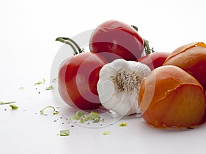 Close-up detail of several tomatoes and a head of garlic photo