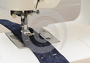 Close-up detail of the sewing machine,blue jeans