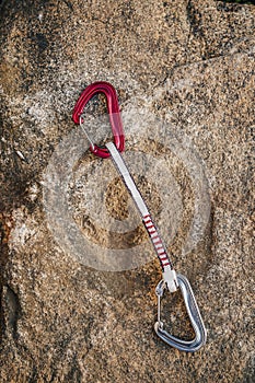 Close up detail shot of a quickdraw, two rock climbing carabiners with a sling or webbing.