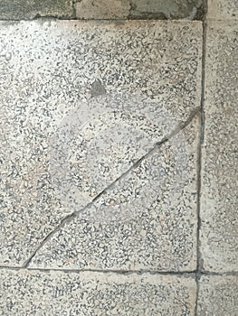 close up detail of the surface of an old ceramic tile or tile floor