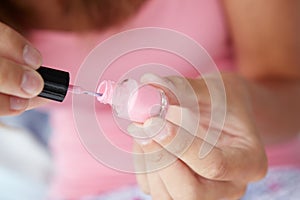 Close up detail teenage girl painting nails