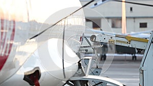 Close-up detail view of belt loading machine car load commercial parcel shipment in small cargo plane compartment. Air