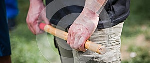 Close-up detail view of filipino escrima instructor holding bamboo stick