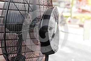 Close-up detail view of fresh moisturized breeze air blowing from big cooling fan machine hot sunny summer weather