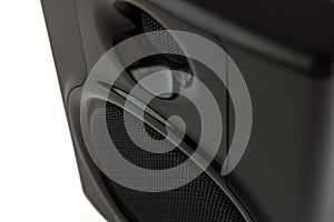 A close up  detail view of a studio speaker from above in front of a white background. - landscape orientation