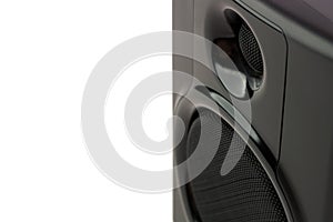 A close up  detail view of a studio speaker in front of a white background. - front view landscape orientation