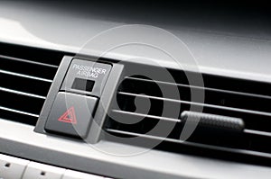 Close up detail of warning lights button and air vents inside a car photo