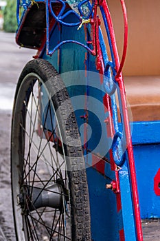Close-up and detail of the wheel from the indonesia traditional blue wooden pedicab calls becak