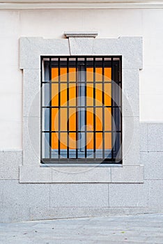 Close-Up Detail of Window with Grille on a White Facade Background