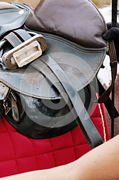 Close up detail of worn leather riding saddle