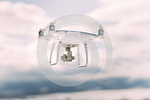 Close up details of drone quadcopter flying in clear blue sky
