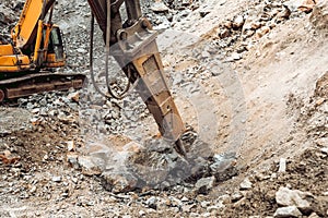 Close up details of excavator scoop and iron breaker on construction site