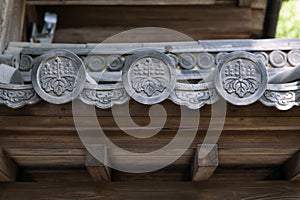 Close up details of Hanagawara or roof tile ornamentation with floral and plant designs in traditional Japanese architecture