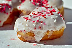 Close-up details of Heart-shaped donuts with tiny red heart sprinkles