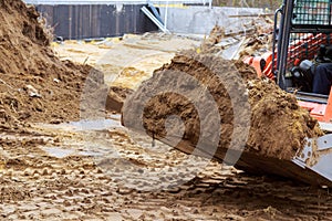 Close up details of industrial excavator working on construction site