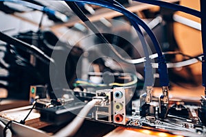 Close up details of mining rig, graphics cards cables and motherboard and network connecton. Modern technology used for mining bit