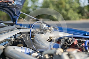 a close up details in the motor engine of a vehicle sport racer car with opened hood