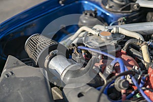 a close up details in the motor engine of a vehicle sport racer car with opened hood