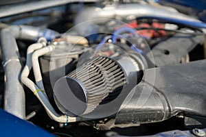 a close up details in the motor engine of a vehicle sport racer car with opened hood