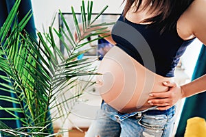 Close up details of pregnant woman in new home - Concept of pregnancy, maternity and motherhood health care, gynaecology, medicine photo