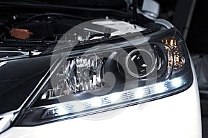 Close up details of projector lens headlights and daytime running light technology.