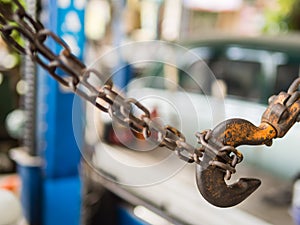 Close up details of rusty chain and hook in car garage, Thailand