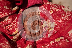 Close up details of the wrinkle hand of a elder nepalese woman