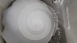 close up of detergent foam in a clothes washing machine
