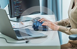 close up developer hand coding with keyboard on desk at modern office