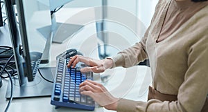 close up developer hand coding with keyboard on desk at modern office